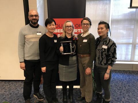 Photo of AAS faculty and staff, with Christine Lyke in the center. Left to right: Junaid Rana, Soo Ah Kwon, Christine Lyke, Kat Fuenty, Mimi Thi Nguyen