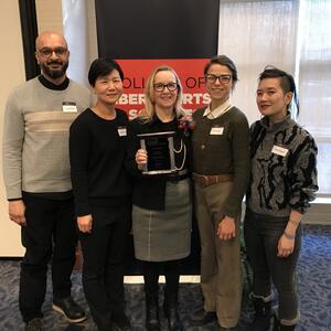 Photo of AAS faculty and staff, with Christine Lyke in the center. Left to right: Junaid Rana, Soo Ah Kwon, Christine Lyke, Kat Fuenty, Mimi Thi Nguyen